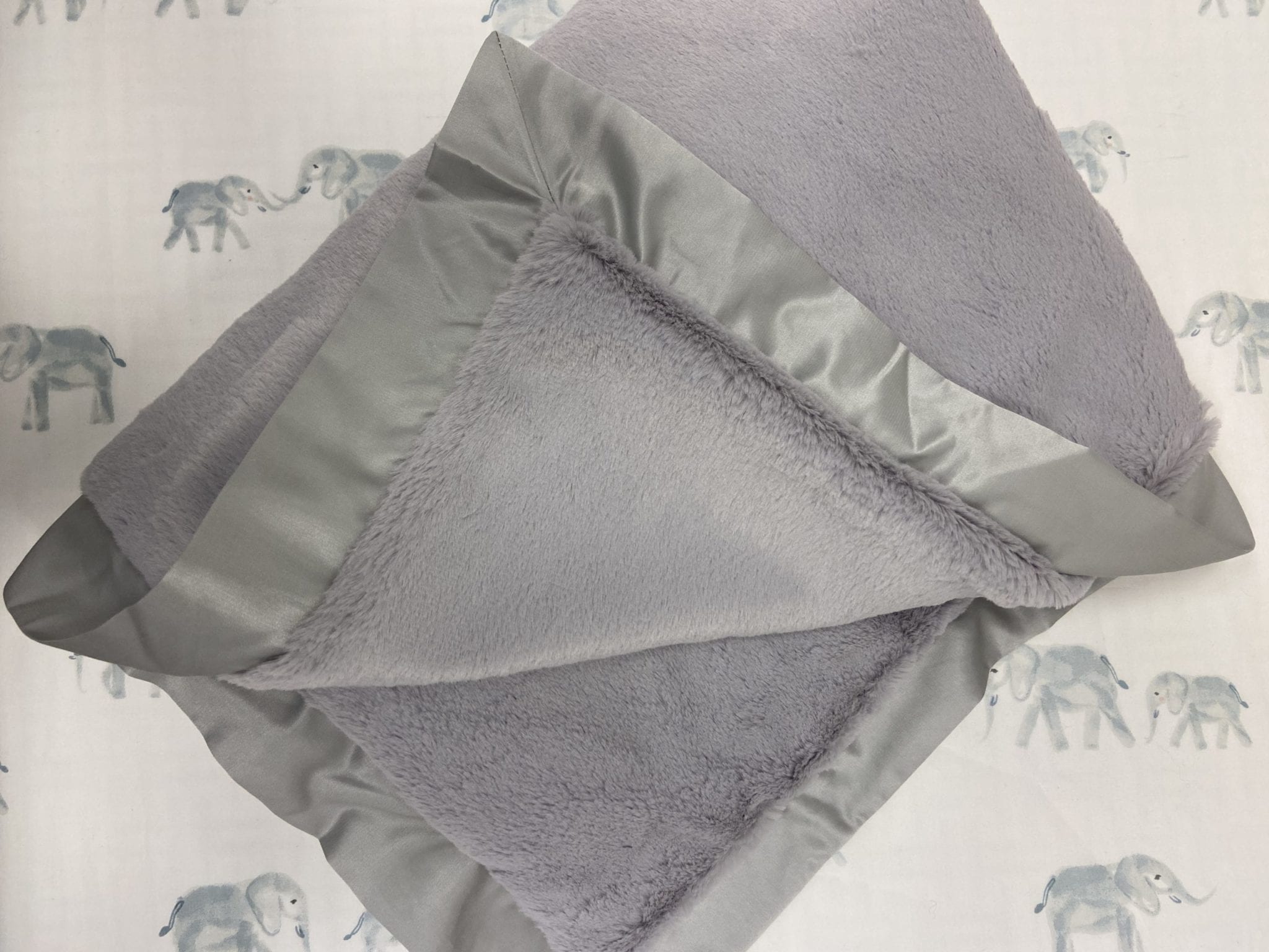 grey faux fur and satin blanket